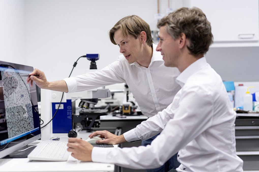 Two men in the laboratory at the computer