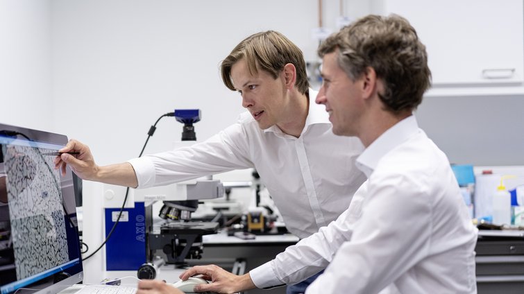 Two men in the laboratory at the computer